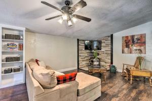 a living room with a ceiling fan and a couch at Relaxing Lincoln Forest Retreat with Wraparound Deck in Cloudcroft