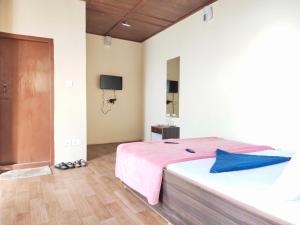 a bedroom with a large bed with a pink blanket at Great Eastern Valley Residency in Gangtok
