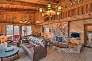 a living room with a couch and a stone fireplace at Eagles Nest - Baraboo Cabin on Wisconsin River! in Baraboo