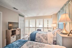 a bedroom with two beds and a flat screen tv at Pet-Friendly A-Frame Retreat Near Dtwn and Beaches! in Pensacola