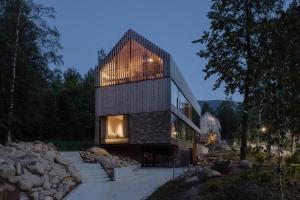 a stone house with a lot of windows and rocks at Wilcza For Rest in Karpacz