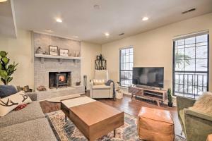a living room with a fireplace and a tv at Modern Mountain Retreat with Deck and Hot Tub! in Chester Gap
