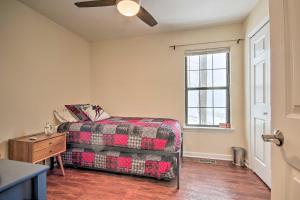 a living room with a bed and a window at Modern Mountain Retreat with Deck and Hot Tub! in Chester Gap