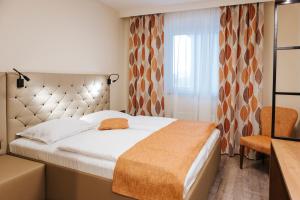 Postel nebo postele na pokoji v ubytování Hotel Der Stockinger