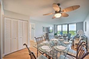 a dining room and living room with a ceiling fan at Resort-Style Condo with Pool, Gym, Tennis and More! in Marco Island