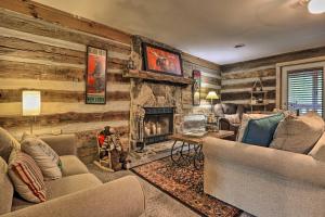 a living room with couches and a fireplace at Riverfront Couples Retreat in Smoky Mountains! in Townsend