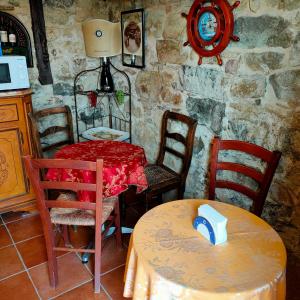 kuchnia ze stołem i krzesłami oraz stołem i szezlongiem w obiekcie La Casa Del Sole w San Remo