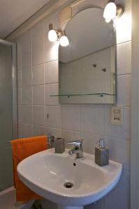 a bathroom with a white sink and a mirror at A Casa di Claudio in Catania