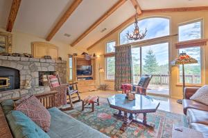 a living room with a couch and a table at Bears Den Cabin with Fenced-In Yard 5 Mi to Lake in Lake Arrowhead
