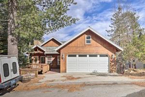 a wooden house with a white garage at Wraparound Deck Woodland Cabin in Lake Arrowhead in Lake Arrowhead