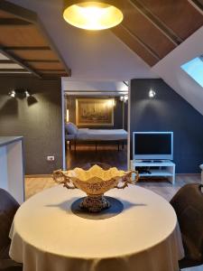 a living room with a table with a vase on it at Amazing Savoya nr1 Loft Old City Center Self check-in in Timişoara