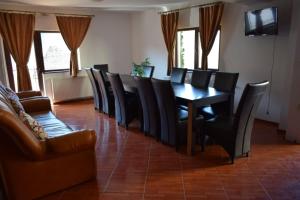 a dining room with a table and black chairs at Casa Gabi in Bran