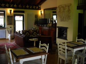 a living room with a table and chairs and a couch at Agriturismo Maiocchi in Borgarello