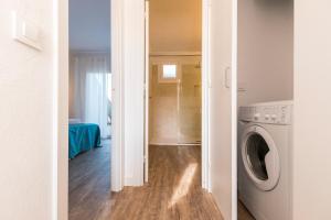 a laundry room with a washer and dryer at Apartamentos Playa Canutells in Mahón
