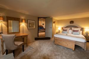 a bedroom with a bed and a desk and a desk at Boringdon Hall Hotel and Spa in Plymouth