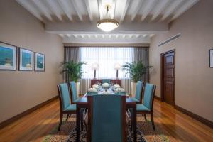 a dining room with a table and blue chairs at Jin Jiang Hotel in Shanghai