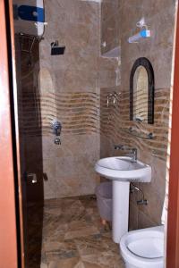 a bathroom with a sink and a toilet at 300M FROM BEACH GLORIAS HOTEL BEACH VIEW in Mandarmoni