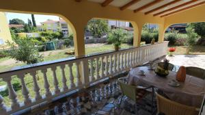 a patio with a table and chairs on a balcony at Apartments Šerbečić in Malinska