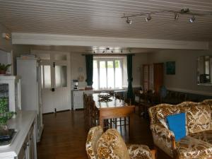 a kitchen and living room with a table and chairs at Les Sources in Saint-Jacques-des-Blats