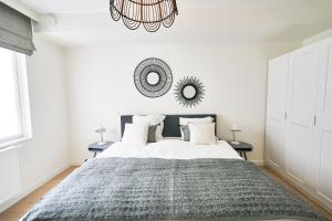 a bedroom with a large bed with a mirror on the wall at Diamant 2BR in Brussels