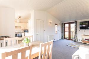 a kitchen and dining room with a table and chairs at Chestnut Lodge With Hot Tub in Malton