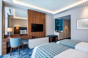Postel nebo postele na pokoji v ubytování Ambassadori Goderdzi Hotel