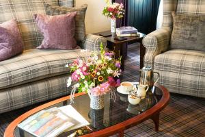 a living room with a coffee table with flowers on it at The Lagg in Lagg
