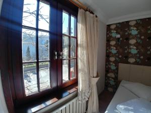A bed or beds in a room at Konak Hotel Tuzla
