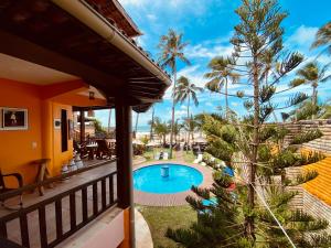 a view from the balcony of a house with a swimming pool at Pousada Janelas do Mar in Flecheiras