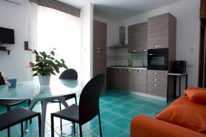 a kitchen and dining room with a table and chairs at L'Ulivo Sul Mare in Cetraro