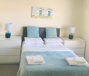 ein Schlafzimmer mit einem Bett mit zwei Handtüchern darauf in der Unterkunft Pavilion Holiday Apartments in Weston-super-Mare