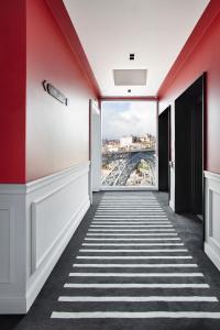 a hallway with red walls and a view of a bridge at Vincci Ponte de Ferro in Vila Nova de Gaia