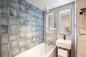a bathroom with a sink and a mirror at Hôtel de L'Esperance in Paris +90 photos