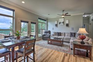 a living room with a couch and a table at Contemporary Mountaintop Cabin 6 Mi to Natl Park in Hot Springs