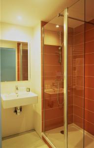 a bathroom with a sink and a shower at Apparthotel Torcy in Torcy