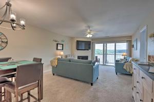 a living room with a couch and a table at The Lake Escape with Balcony and Pool Access! in Camdenton