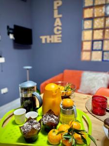 a table with a green tray with pastries on it at The Place in Terrasini