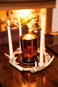 a candle sitting on a table with candles on it at The Lagg in Lagg