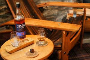 a bottle of beer and two glasses on a table at The Lagg in Lagg