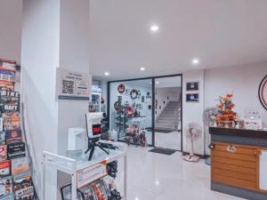 a room with a store with a window and a staircase at Rinn Boutique House in Chiang Mai