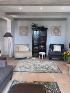 a living room with two couches and a rug at Claire de Lune in Puyloubier +32 photos