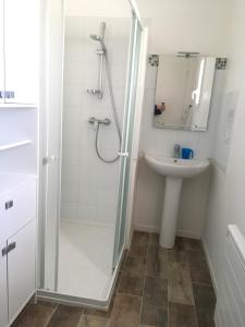 a bathroom with a shower and a sink at Le sable chaud in Saint-Pierre-dʼOléron