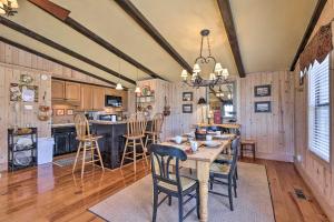 a kitchen and dining room with a table and chairs at Cozy Caymus Cabin about 3 Miles to Callaway Gardens! in Pine Mountain