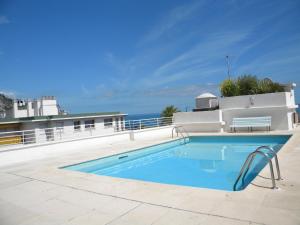 a swimming pool with a view of the ocean at app Le Rocazur avec piscine et parking en bord de mer à 500M du centre ville in Menton