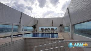 a swimming pool on top of a building at Apto. 1 dorm. no Edf. Manhattan home service 605 in Caruaru