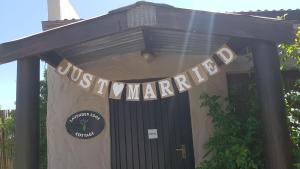 a sign over a door with a sign for a restaurant at Forest Valley Cottages in Knysna