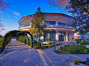 a building with an umbrella in front of it at Lebada Luxury Resort & Spa in Crisan