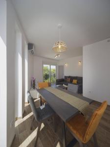 una sala da pranzo e un soggiorno con tavolo e sedie. di Apartments STEP a Kotor (Cattaro)