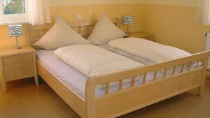 a bed with two pillows on it in a bedroom at Feriendomizil Carmen Hofmann in Absberg