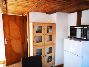 a kitchen with a refrigerator and a cabinet with a microwave at charmante Pension zentral in Reutlingen
